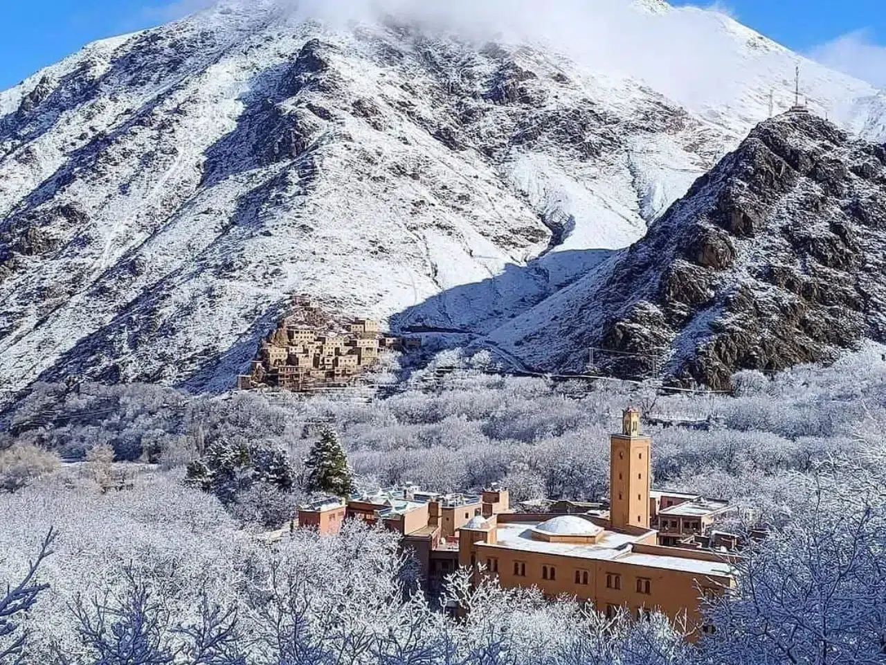 Scenic view of the Atlas Mountains during a day trip, showcasing lush valleys and snow-capped peaks.